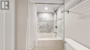 Mississauga (Applewood) condo for rent - A white bathroom with a tub and shower.