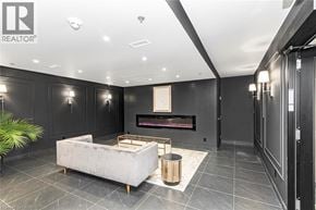 Ancaster condo for rent - A modern living room with a fireplace and a white sofa.