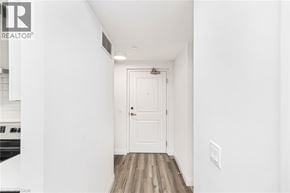 Ancaster condo for rent - A white door is at the end of a hallway.