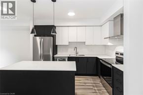 Ancaster condo for rent - A modern kitchen with a black and white color scheme.