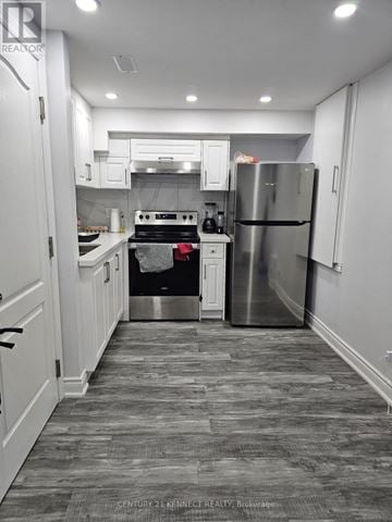 Brampton (Heart Lake East) apartment for rent - A kitchen with a stove, refrigerator, and cabinets.