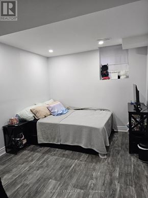 Brampton (Heart Lake East) apartment for rent - A bedroom with a bed, a nightstand, and a desk.