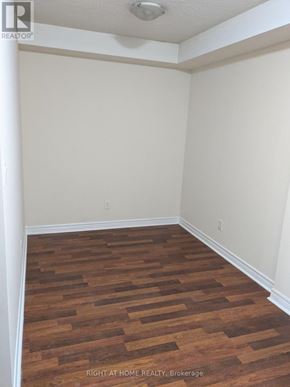 Mississauga (City Centre) condo for rent - A room with wooden flooring and white walls.