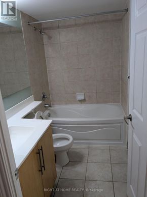Mississauga (City Centre) condo for rent - A bathroom with a toilet, sink, and bathtub.