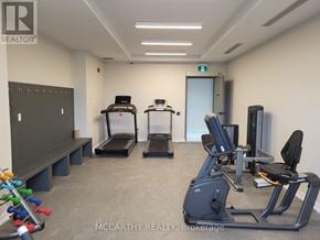 Southgate condo for rent - A gym room with treadmills, exercise bikes, and a bench.