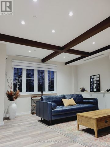 Southgate condo for rent - A living room with a blue couch and a wooden coffee table.