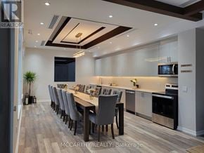 Southgate condo for rent - A modern dining room with a long table and chairs.