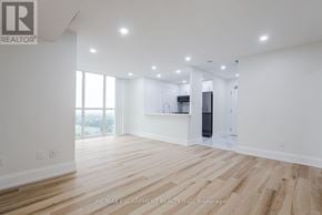 Mississauga (City Centre) condo for rent - A spacious room with wooden flooring and white walls.