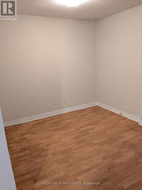 Mississauga (City Centre) condo for rent - A room with wooden flooring and white walls.