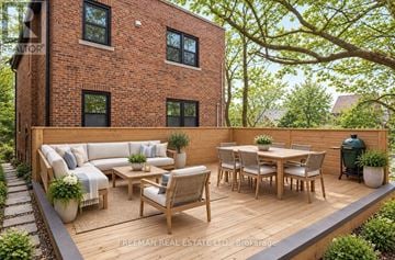 Toronto (Casa Loma) apartment for rent - A wooden deck with a table and chairs is in front of a brick building.