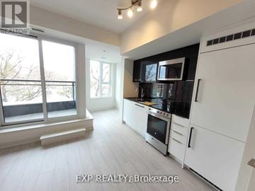 Toronto (Birchcliffe-Cliffside) condo for rent - A modern kitchen with white cabinets and stainless steel appliances.