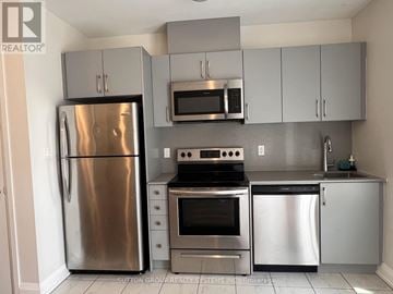 Toronto (Islington-City Centre West) townhouse for rent - A kitchen with a stainless steel refrigerator, oven, and microwave.