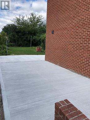 Toronto (Kingsview Village-The Westway) apartment for rent - A brick wall with a concrete slab in front of it.