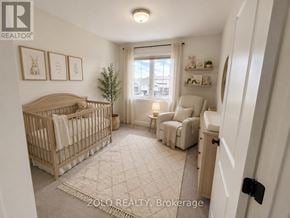 Smiths Falls townhouse for rent - A well-lit nursery room with a crib, a chair, and a small tree.