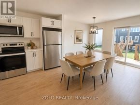 Smiths Falls townhouse for rent - A kitchen with a dining table and chairs.