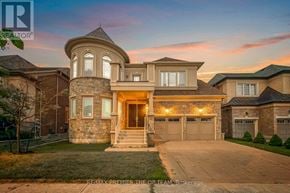 Vaughan (Kleinburg) apartment for rent - A large house with a stone facade and a large front yard.