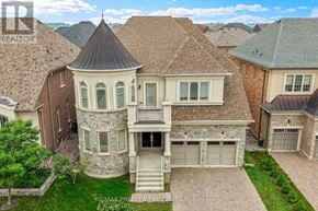 Vaughan (Kleinburg) apartment for rent - A large house with a tower-like structure on the roof.