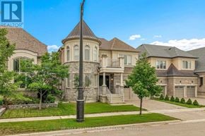 Vaughan (Kleinburg) apartment for rent - A large, well-maintained house with a stone pillar in the front yard.