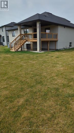 Amherstburg apartment for rent - A house with a deck and stairs in front of it.
