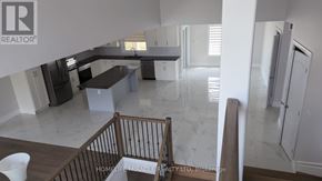 Amherstburg apartment for rent - A realtor company logo is on the wall of a spacious kitchen.