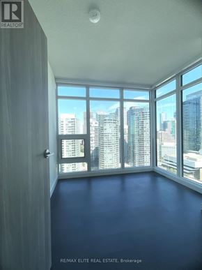 Toronto (Waterfront Communities) condo for rent - A room with a view of the cityscape through large windows.