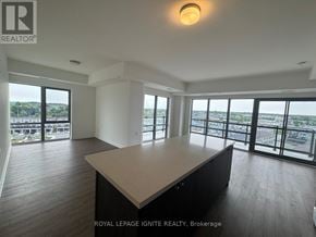 Clarington (Bowmanville) condo for rent - A spacious room with a large table and a view of the city.