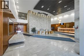 Mississauga condo for rent - A reception area with a stone wall and a blue rug.