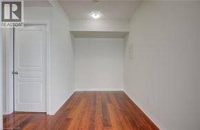 Mississauga condo for rent - A room with a white door and wooden floors.