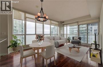 Mississauga condo for rent - A well-lit, spacious living room with a dining table and chairs.