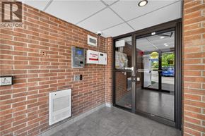 Guelph condo for rent - A brick wall with a sign that says REALTOR on it.