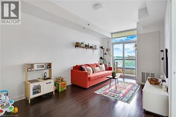 Cambridge condo for rent - A living room with a red couch and a wooden cabinet.