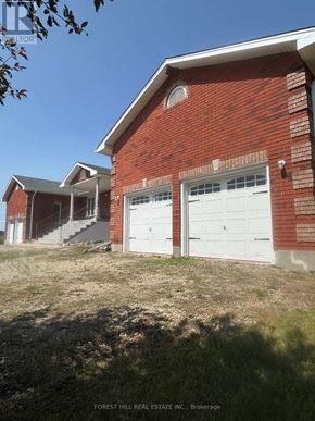 East Garafraxa apartment for rent - A house with a brown roof and a white garage door is surrounded by a grassy field.