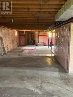 East Garafraxa apartment for rent - A room under construction with exposed wooden beams and unfinished walls.
