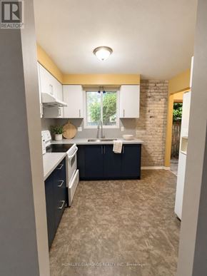Welland (N. Welland) apartment for rent - A kitchen with a sink, stove, and cabinets.