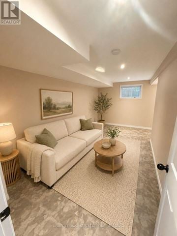 Welland (N. Welland) apartment for rent - A living room with a white couch, a small table, and a painting on the wall.