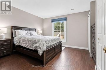 London North (North P) townhouse for rent - A bedroom with a large bed and a window with a view of trees.