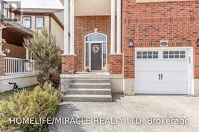 Kitchener apartment for rent - A brick house with a white garage door and a black door.