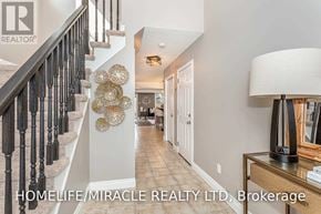 Kitchener apartment for rent - A hallway with a staircase and a lamp on a table.