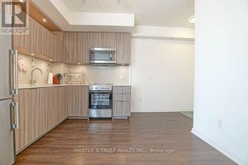 Toronto (Henry Farm) condo for rent - A kitchen with a refrigerator, microwave, and oven.