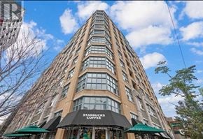 Toronto (Waterfront Communities) condo for rent - A tall building with a Starbucks on the ground floor.