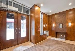 Toronto (Waterfront Communities) condo for rent - A lobby with wood paneling and a reception desk.