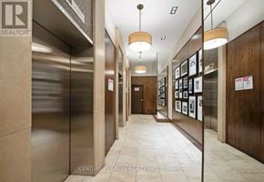 Toronto (Waterfront Communities) condo for rent - A hallway with a realtor sign on the wall.