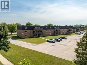 London apartment for rent - A large building with a parking lot in front of it.