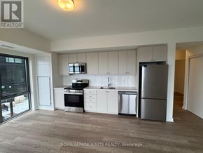 Clarington (Bowmanville) condo for rent - A kitchen with white cabinets and stainless steel appliances.