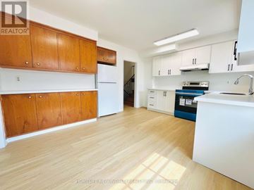 Toronto (Willowdale East) apartment for rent - A kitchen with wooden cabinets and a white refrigerator.
