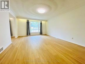 Toronto (Willowdale East) apartment for rent - A room with wooden flooring and a window with curtains.