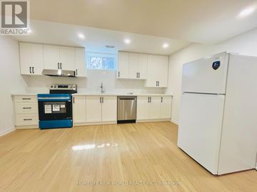 Toronto (Willowdale East) apartment for rent - A kitchen with white cabinets and a blue appliance.
