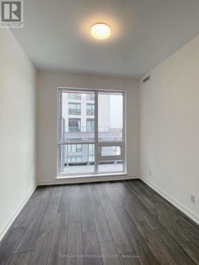 Richmond Hill (South Richvale) condo for rent - A room with a large window and wooden flooring.
