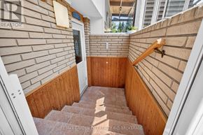 St. Catharines (Lakeport) apartment for rent - A staircase with wooden steps and a brick wall on one side.