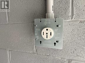 Mississauga (Mineola) apartment for rent - A wall socket with a key slot and a key inserted.